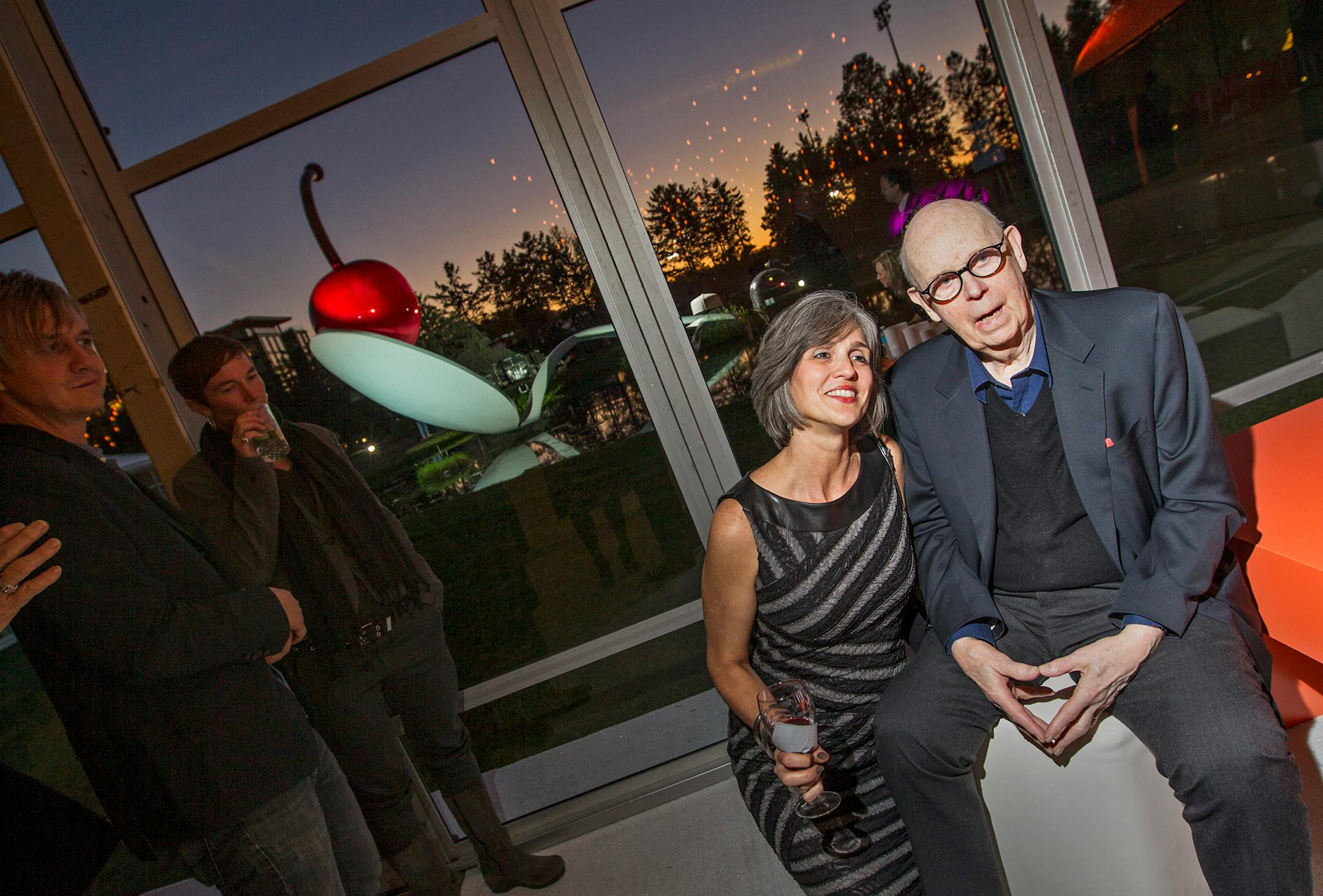 Walker Art Center director Olga Viso, left, poses for a photo with artist Claes Oldenburg as Oldenburg's "Spoonbridge and Cherry" peeks through in the background at Avant Garden at the Walker Art Center September 21, 2013.