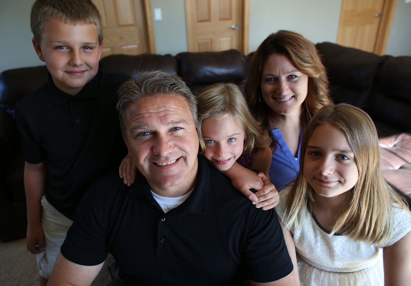 The Hoffner family. Todd and Melodee with their children Mara, 7, Brady, 10 and Kiaya, 11. ] (KYNDELL HARKNESS/STAR TRIBUNE) kyndell.harkness@startribune.com At the home of Todd Hoffner, who lost his job at Minnesota State Mankato as football coach when he was accused of taking inappropriate pictures of his children on a University-issued cell phone, but later cleared an got his job back in Mankato Min. Tuesday, August, 12, 2014.