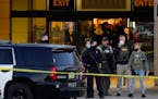 FBI officials and police stand outside the Mayfair Mall after a shooting, Friday, Nov. 20, 2020, in Wauwatosa, Wis.
