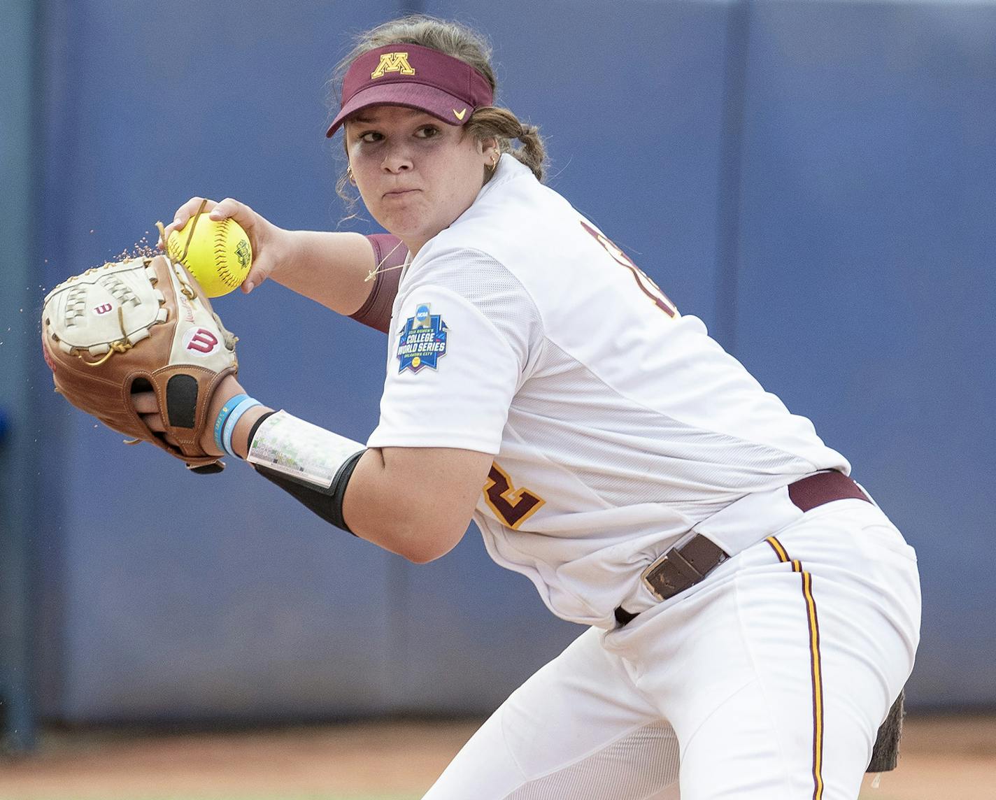 Minnesota pitcher Sydney Smith throws to first base for the Washington out during the seventh inning of the Women's College World Series at ASA Hall of Fame Stadium in Oklahoma City on Saturday, June 1, 2019. Washington won 5-3. Photo by: Alonzo J. Adams