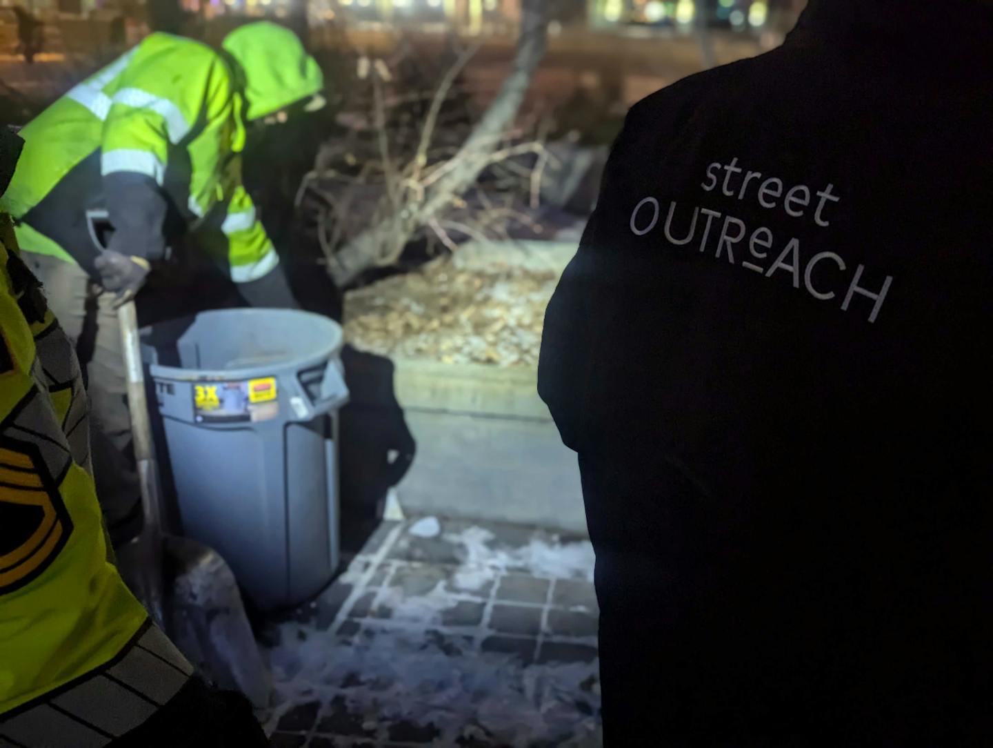 St. Paul workers clear the sidewalk where Jeff, an unsheltered man, slept moments before.