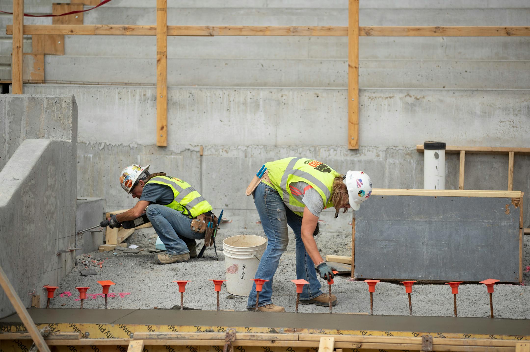 Beth Bombardo chiseled concrete inside the Allianz Stadium while Kelly Wallin capped rebar protruding from freshly poured concrete. Bombardo has been a laborer for more than 20 years, the past 18 or so with M.A. Mortenson Co. Wallin has worked for the company for the last four years. ] JEFF WHEELER • jeff.wheeler@startribune.com
