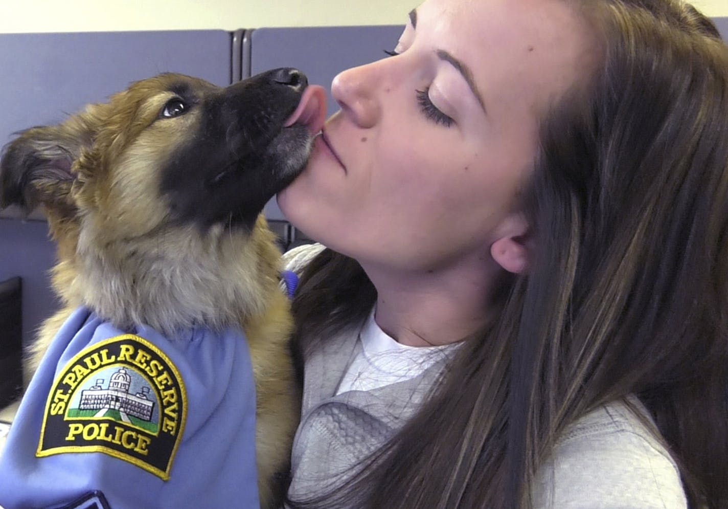 St. Paul police officer Ashley Leopold enjoyed getting kisses from Sgt. Fuzz.