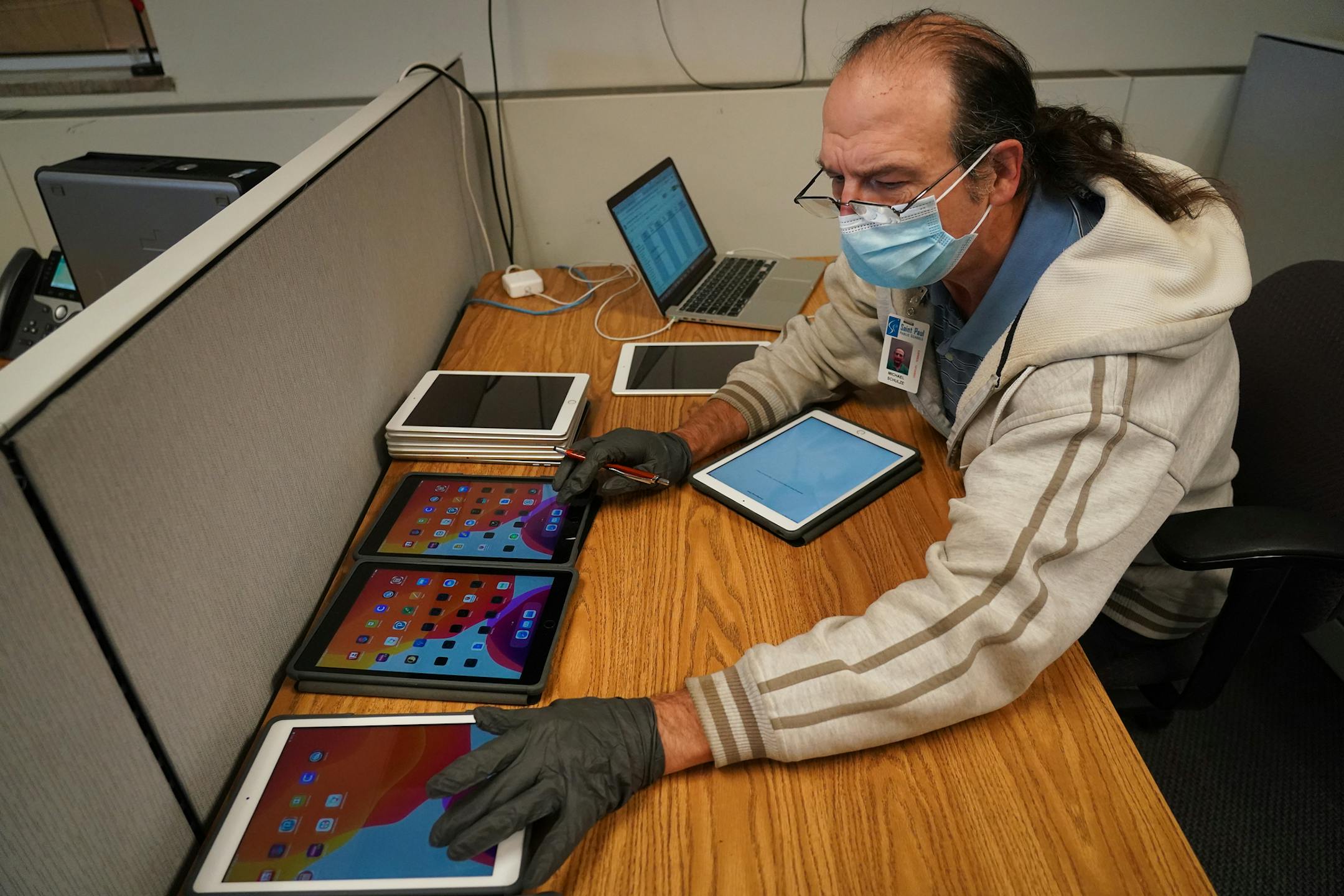 Michael Schulze prepared several iPads to be deployed to students. ] Shari L. Gross • shari.gross@startribune.com As St. Paul students continue to learn at home, district leaders have determined what it will take to get at least some kids back to school part-time. It's no easy lift. A 24-item checklist has been set up to allow for the shift from distance learning to a hybrid of remote and in-person instruction, and 16 goals are deemed important enough that a failure to meet just one would scuttl