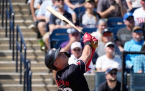 Minnesota Twins left fielder Michael Helman watches a fly ball during the second inning of a spring training baseball game Monday, Feb. 26, 2024, in T
