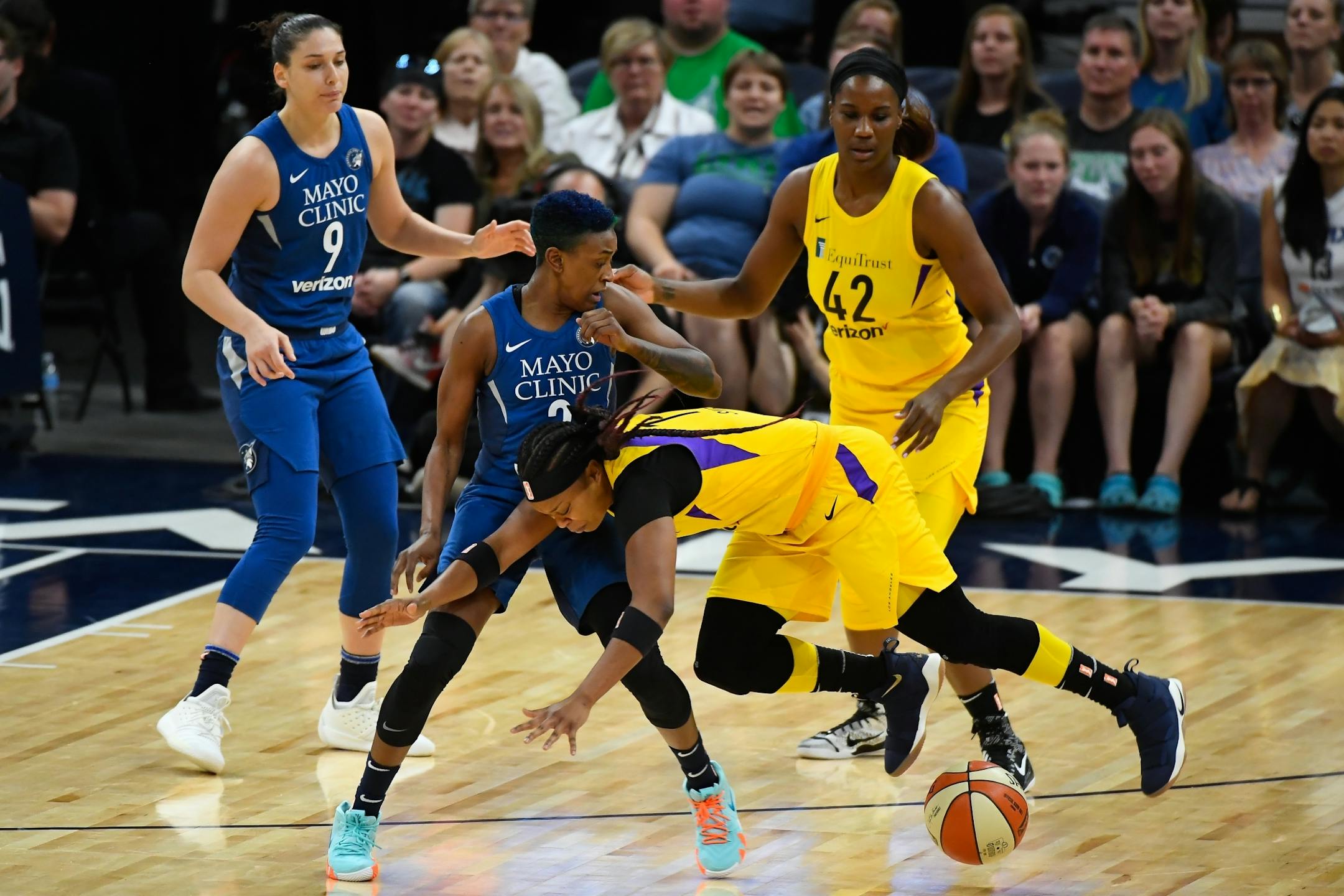 Los Angeles Sparks guard Odyssey Sims (1) was knocked off her feet as Minnesota Lynx guard Danielle Robinson (3) stripped the ball from Sims in the first quarter.