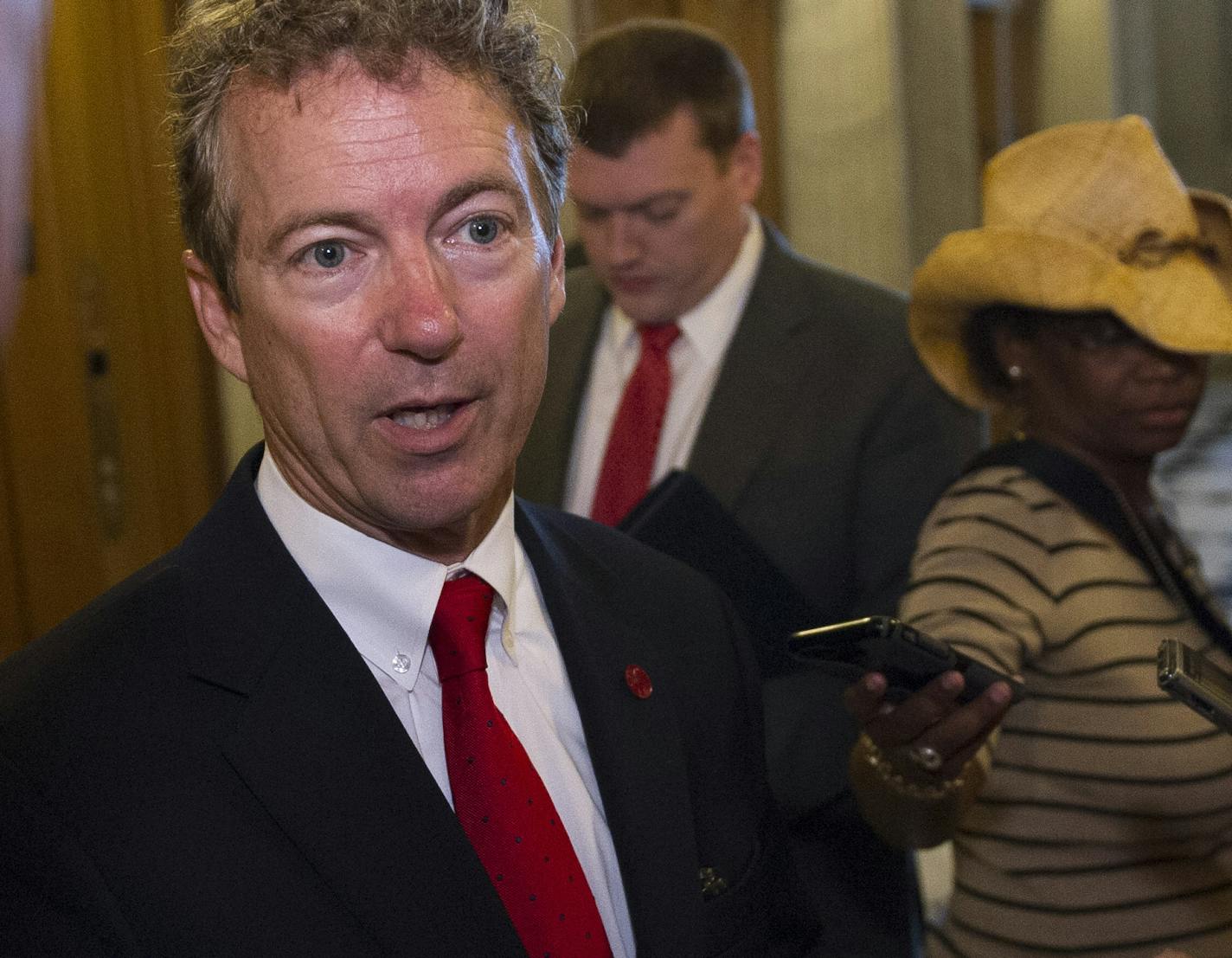 Sen. Rand Paul, R-Ky., talks with reporters outside of the Senate Chamber following his address to the Senate Sunday night.