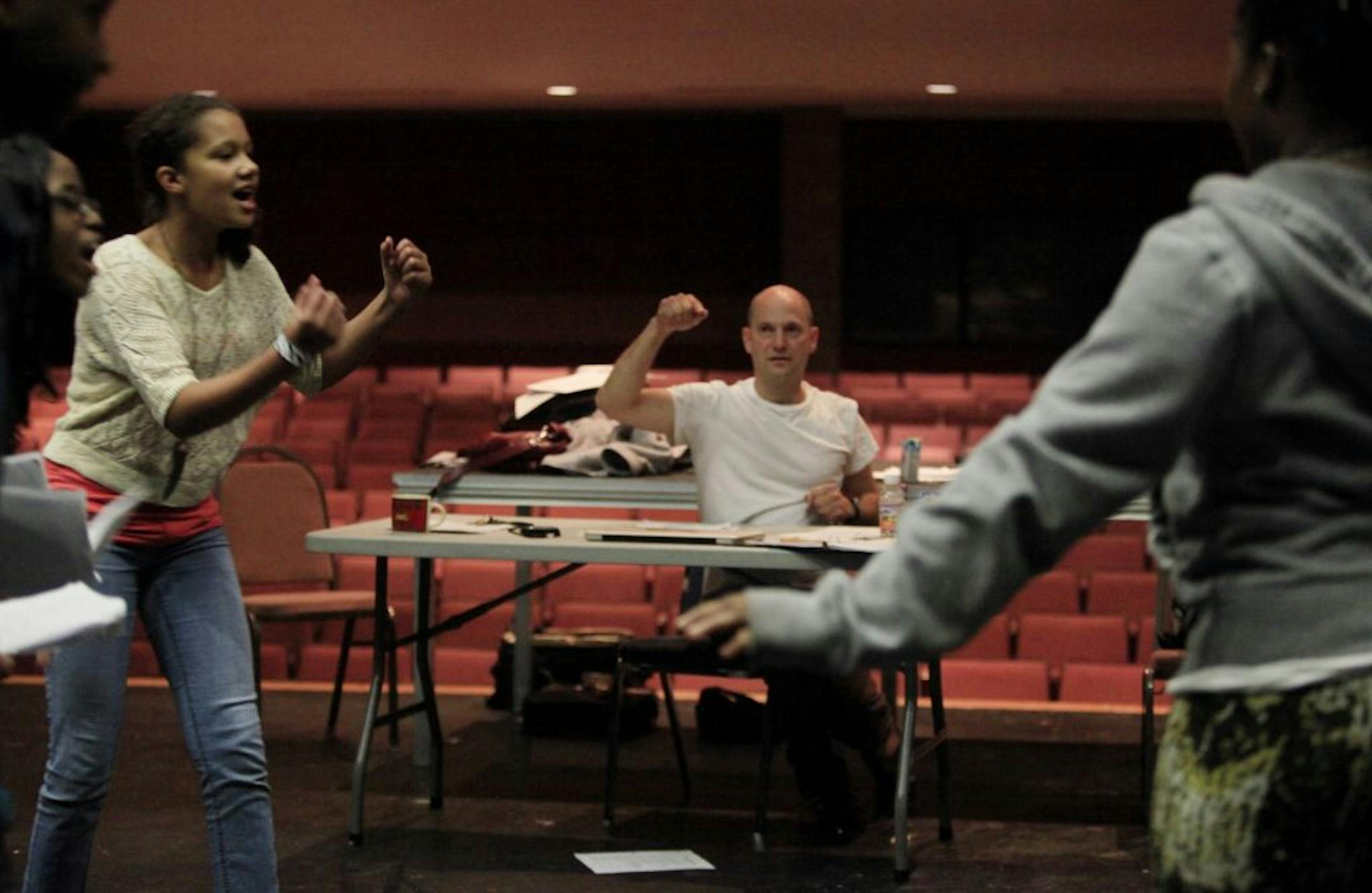 Left ro right: Ashley Koudou ( just face with glasses, 10th grade), Melodie Hunt ( 8th grade), Julian McFaul ( drama teacher and play director), and Grace Bockarie (gray shirt on right, 9th grade) reherse a play at Brooklyn Center High School. Brooklyn Center, MN on September 19, 2012.