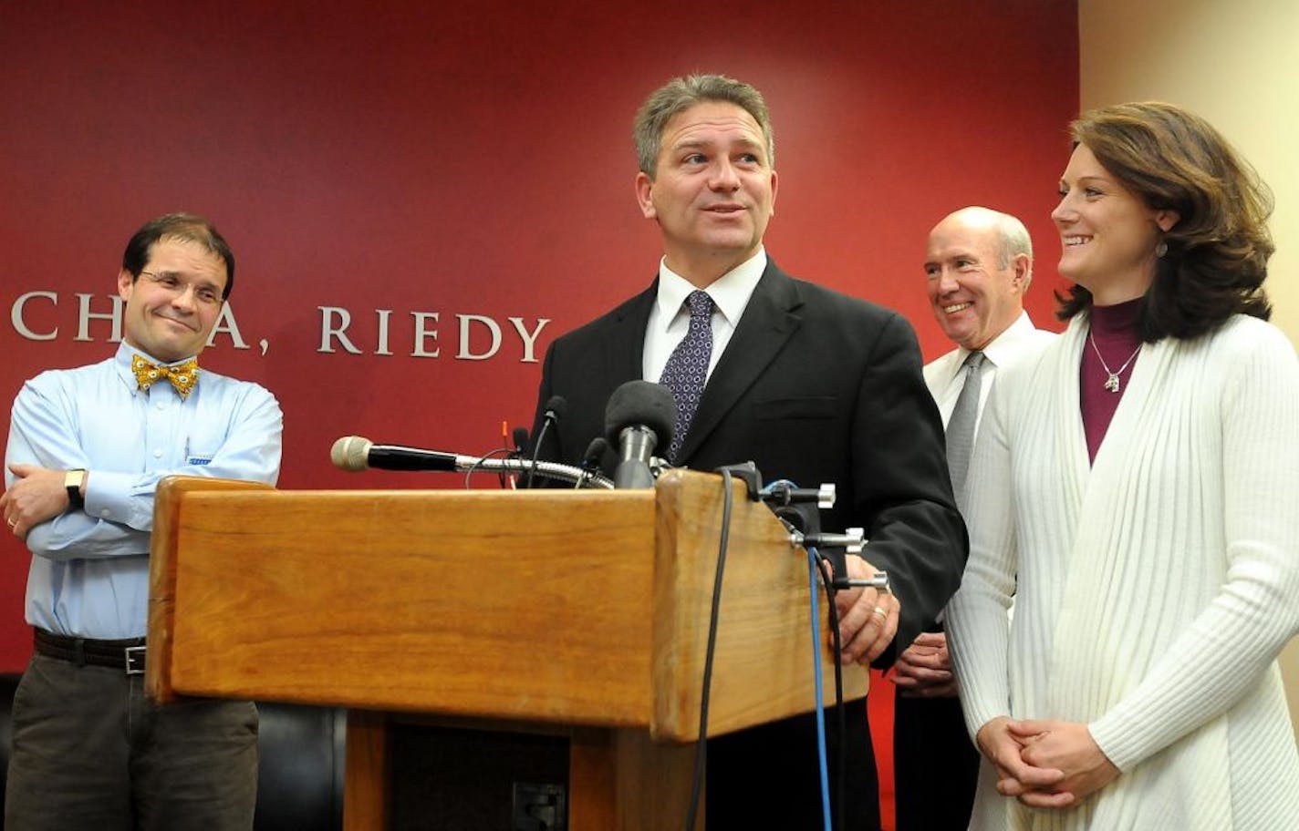 Minnesota State, Mankato football coach Todd Hoffner speaks to reporters as his wife, Melodee, right, attorneys Jim Fleming, left, and Gerald Maschka, second left, listen, Friday, Nov. 30, 2012, in Mankato, Minn. Hoffner, who had been sidelined by accusations of child pornography involving his own children, reacted with relief Friday after a judge dismissed the case, saying he was "thankful to be waking up from this nightmare." Hoffner was effectively cleared when a Blue Earth district judge agr