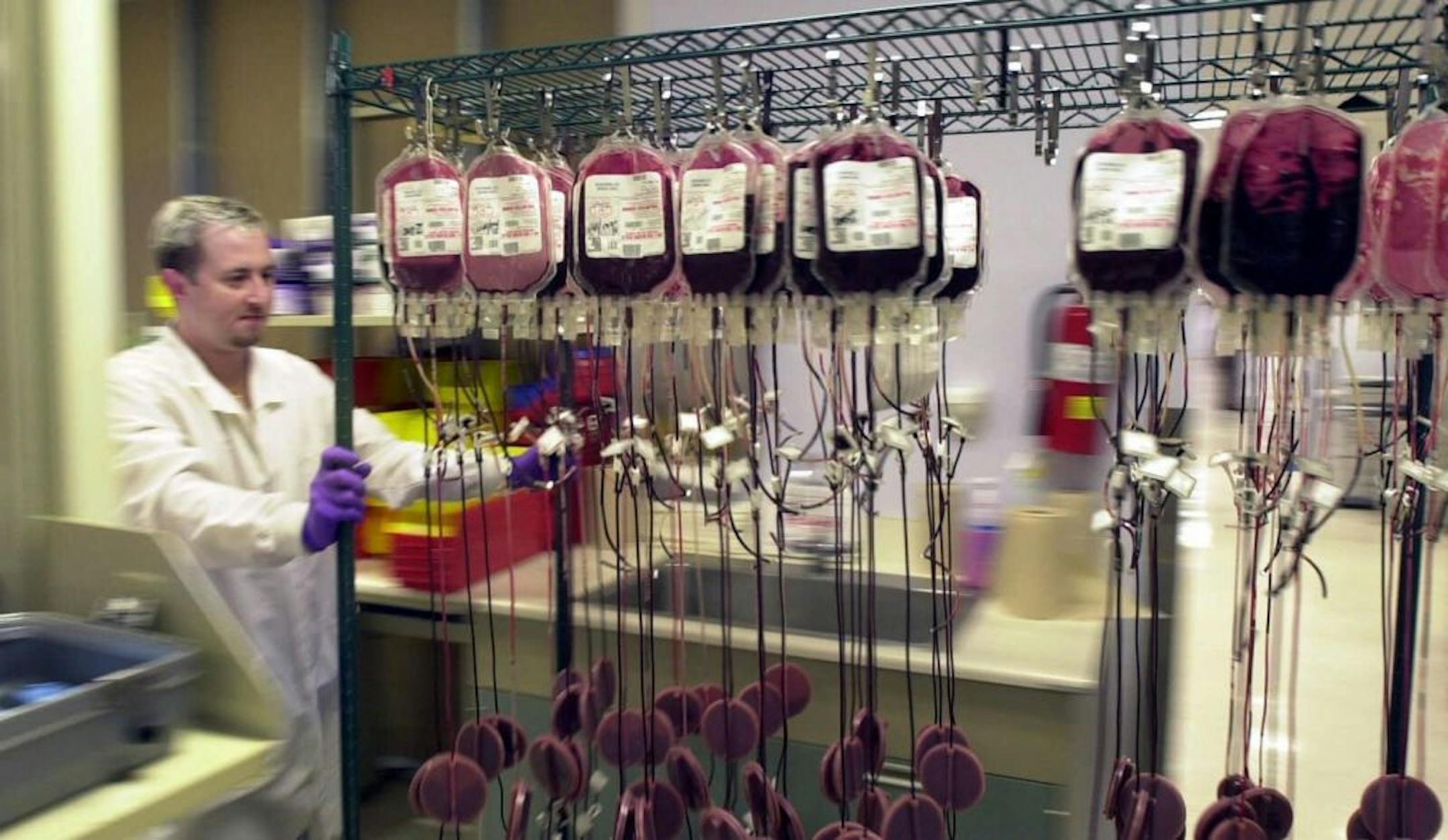 Lab technician assistant Danny Haddock transports a load of donated blood into a cooler at the American Red Cross in Atlanta last week. Giving blood is as simple as it is quick and its benefits include saving lives.