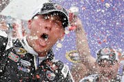 Kevin Harvick celebrates in Victory Lane with his crew after winning the NASCAR Sprint Cup Series auto race Sunday, March 2, 2014, in Avondale, Ariz.
