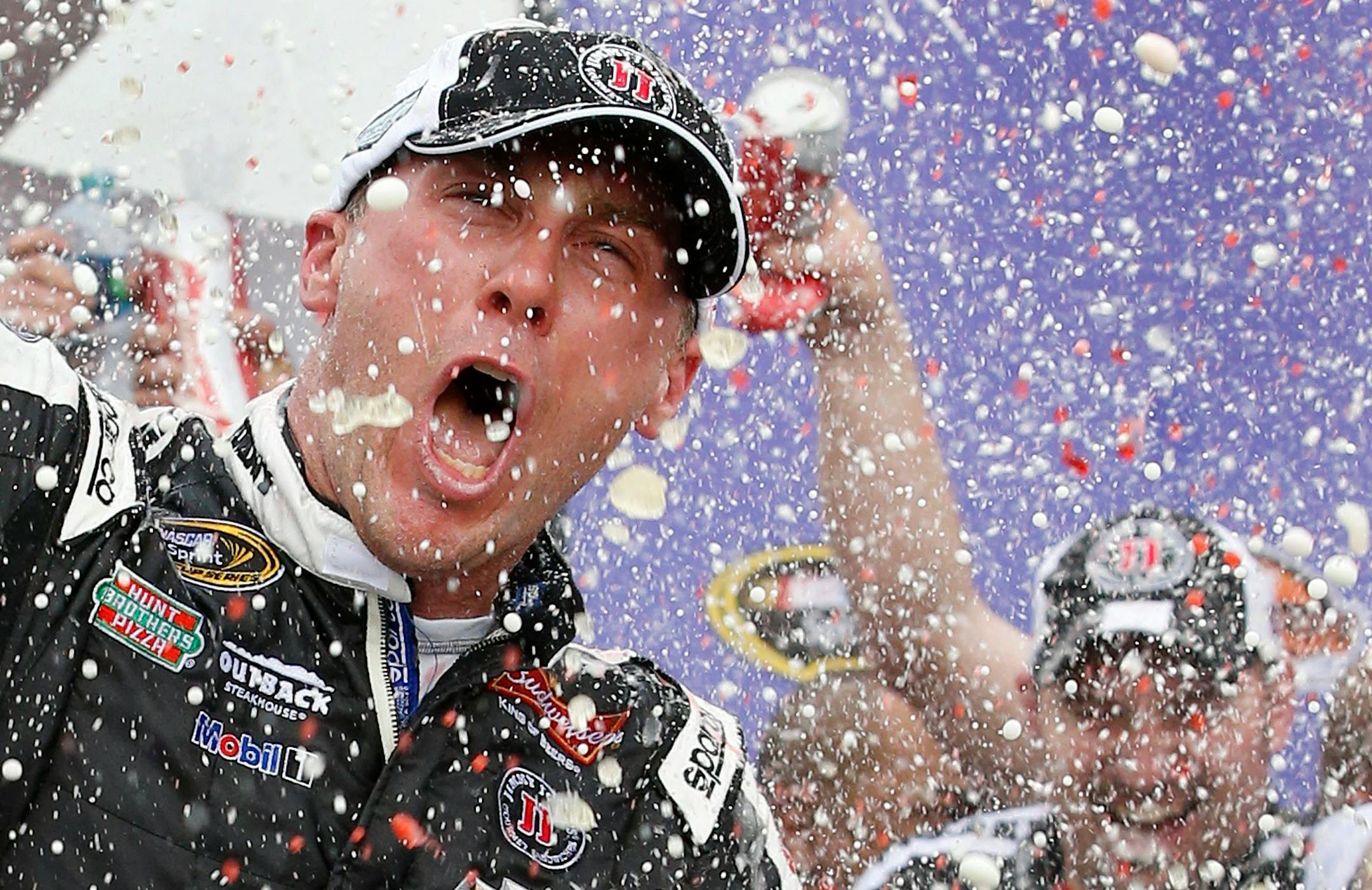 Kevin Harvick celebrates in Victory Lane with his crew after winning the NASCAR Sprint Cup Series auto race Sunday, March 2, 2014, in Avondale, Ariz.