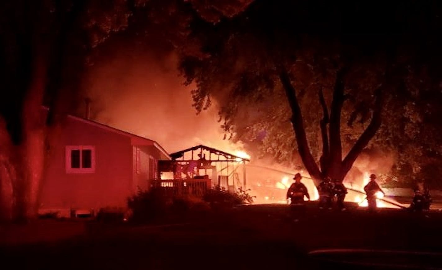 Firefighters battle a blaze in a suspected case of arson at the home of Brooklyn Center Trump supporters Dennis and Deana Molla.