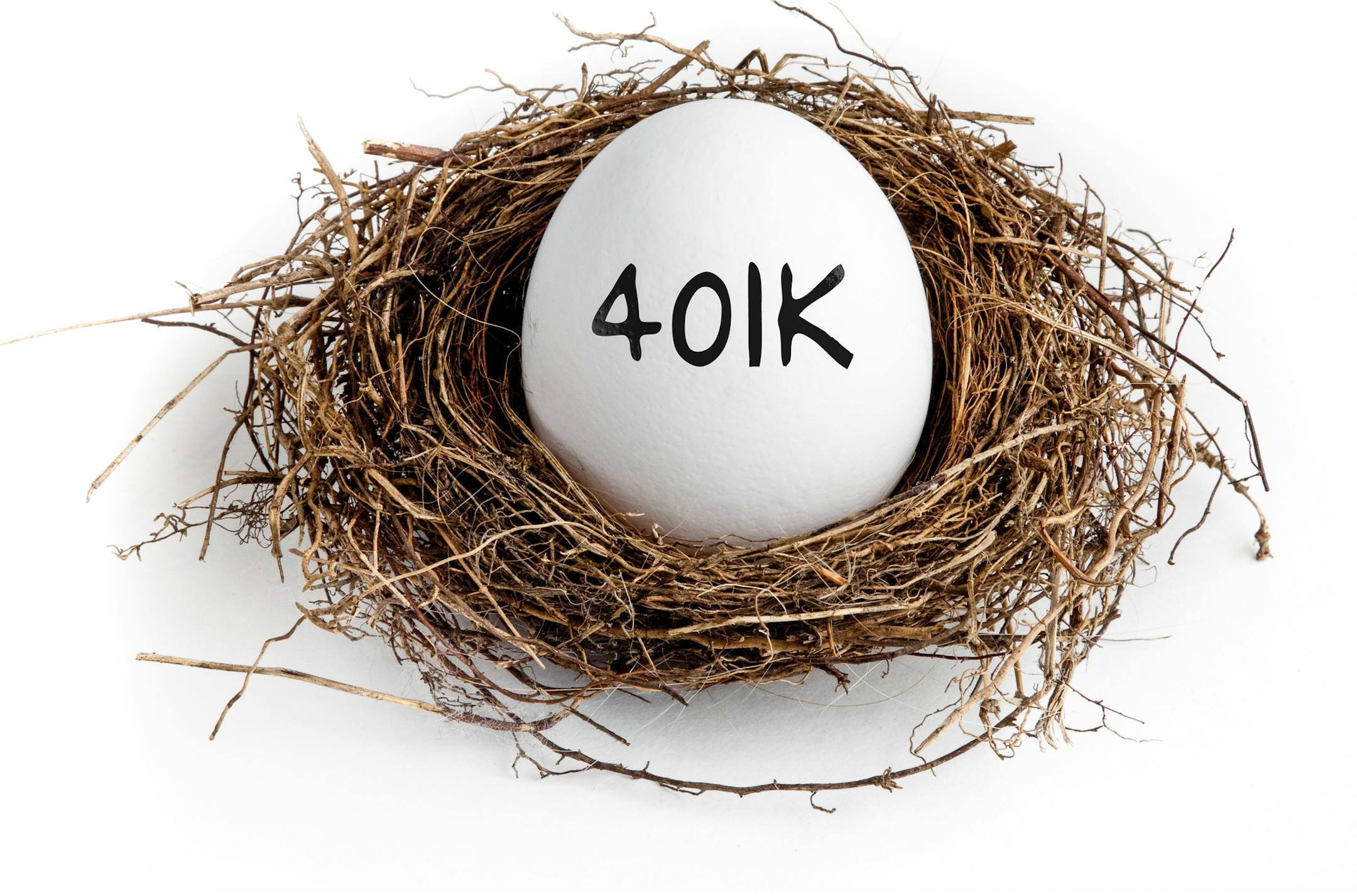 A white egg in a nest on a white background with the word 401K on the egg.
