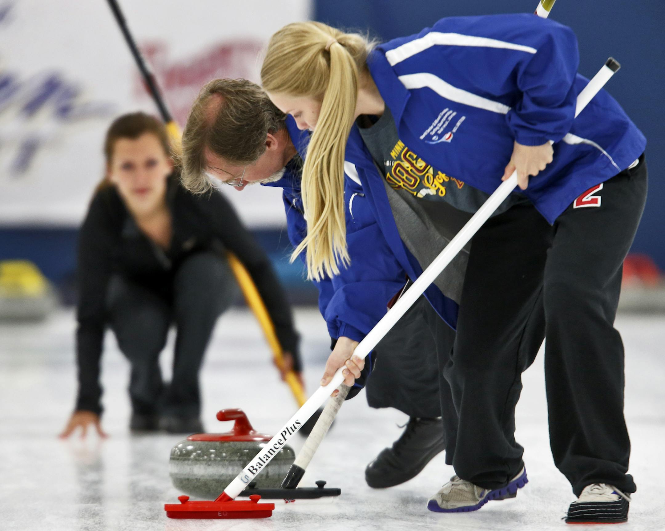Curling activities at Fogerty Arena in Blaine. St. Paul Curling Club (SPCC) competed against Doug White team from New Hope. Jim Honsvall and Julia Gibbs, 14, swept the rock as Amanda Honsvall, left, watched her shot. All from SPCC. (MARLIN LEVISON/STARTRIBUNE(mlevison@startribune.com (cq )