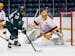 Michigan State's Josh Nodler (20) shoots at Minnesota's Jack LaFontaine (45) during an NCAA college hockey game in the Big Ten Hockey Tournament game 