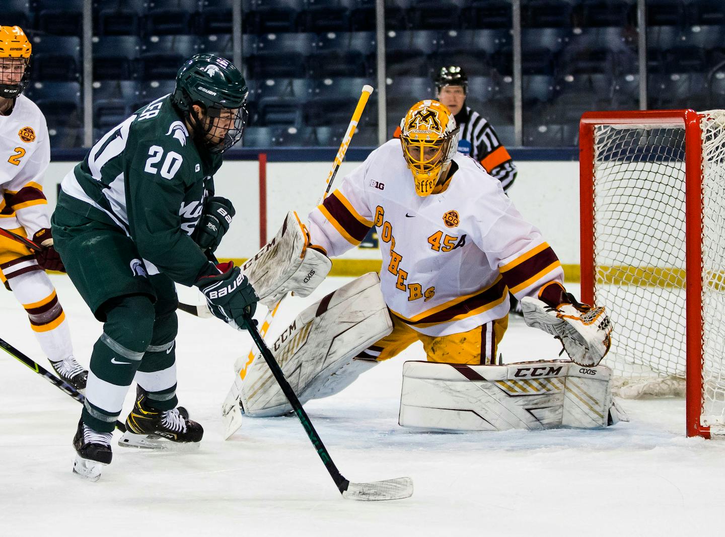 Michigan State's Josh Nodler (20) shoots at Minnesota's Jack LaFontaine (45) during an NCAA college hockey game in the Big Ten Hockey Tournament game Sunday, March 14, 2021, in South Bend. (Michael Caterina/South Bend Tribune via AP)