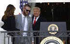 President Donald Trump invites Washington Nationals starting pitcher Stephen Strasburg, second from left, to speak at the podium during an event to ho