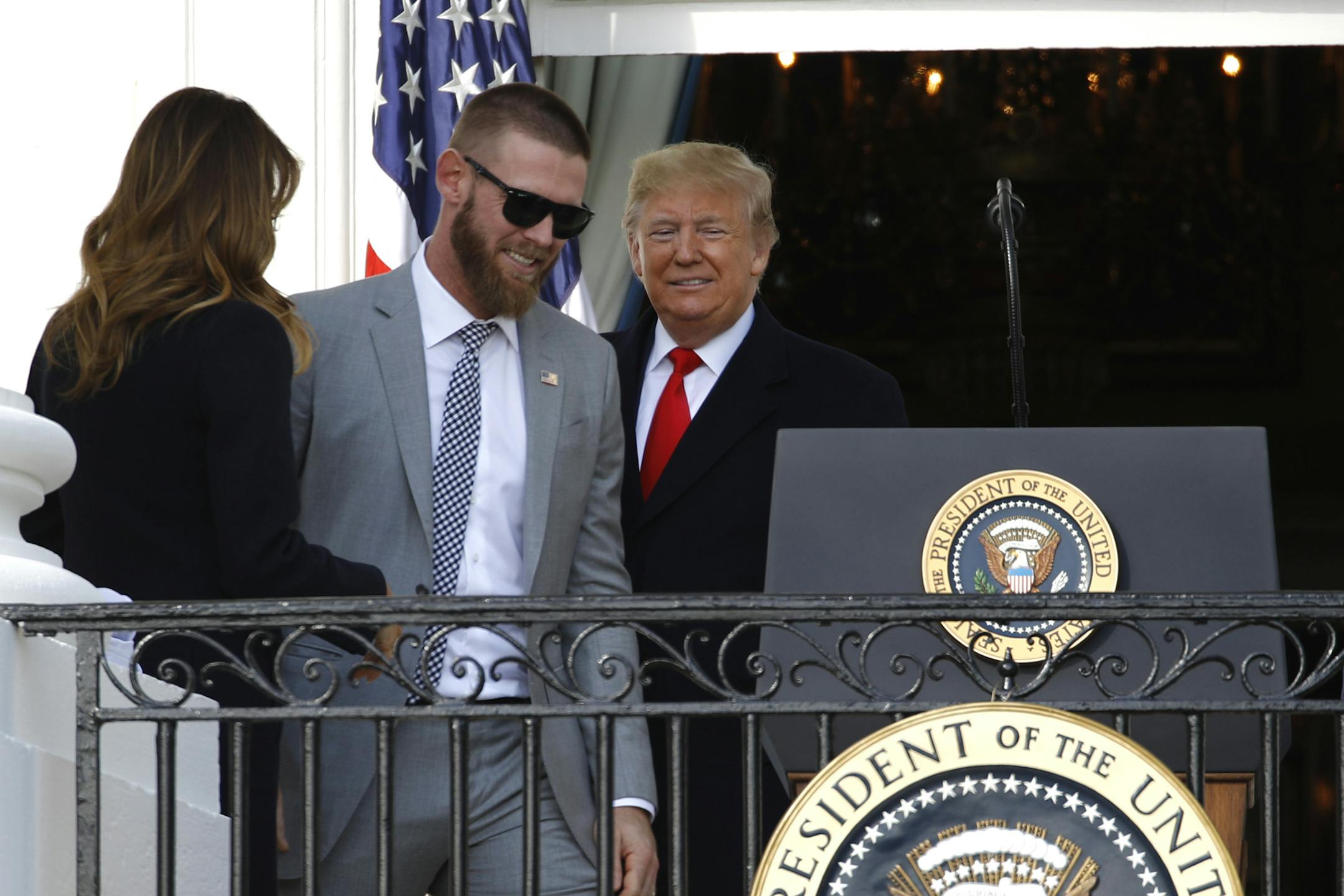 President Donald Trump invites Washington Nationals starting pitcher Stephen Strasburg, second from left, to speak at the podium during an event to honor the 2019 World Series champion Nationals baseball team at the White House, Monday, Nov. 4, 2019, in Washington, as first lady Melania Trump watches. (AP Photo/Patrick Semansky)