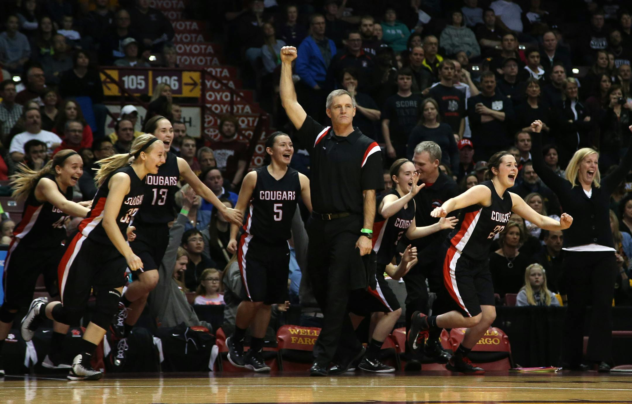 Ada-Borup's coach David Smart put his fist in the air as time ran down while his bench players rushed the court celebrating their championship win. ] (KYNDELL HARKNESS/STAR TRIBUNE) kyndell.harkness@startribune.com Class1A girls' basketball finals Ada-Borup vs Maranatha Christian Academy at Williams Arena in Minneapolis Min., Saturday, March 21, 2015.Ada-Borup won over Maranatha Christian Academy 82-65