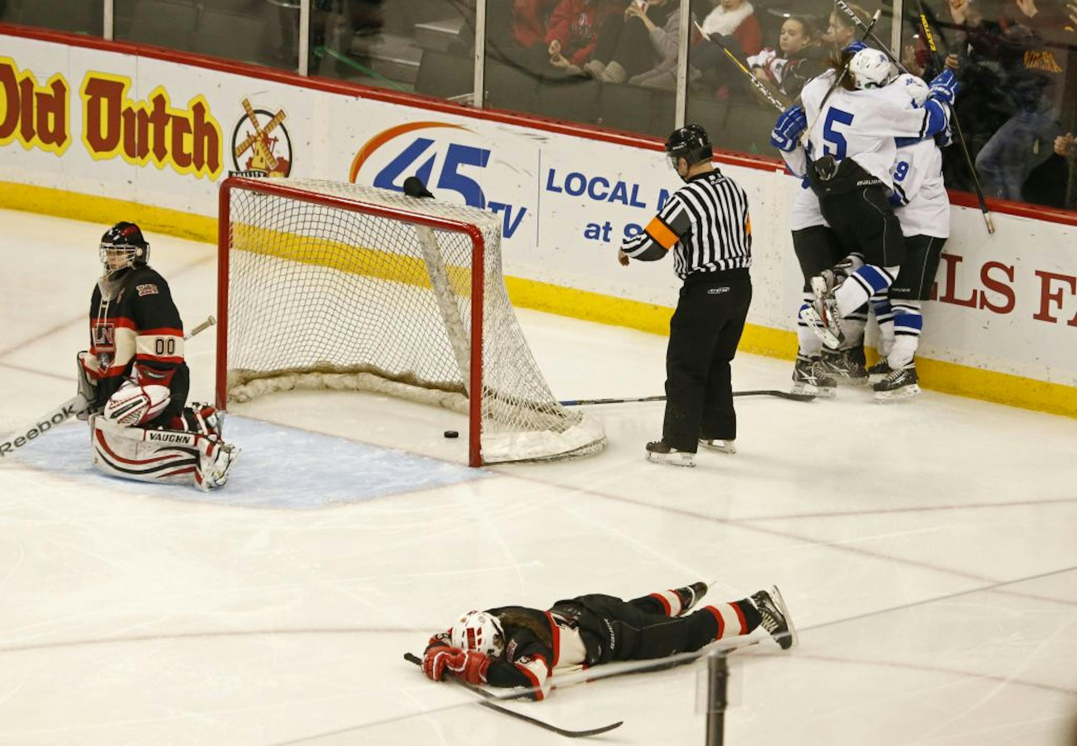 Minnetonka's Amy Petersen (#9 top right) celebrates her goal in the sixth overtime against Lakeville North.