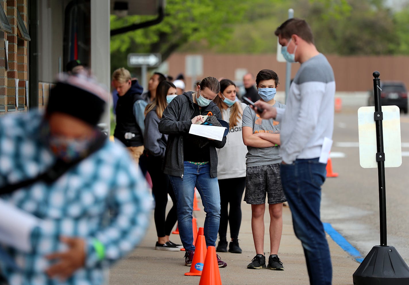 Sixteen DVS exam stations reopened in May, including this one in Arden Hills, where during the midmorning May 19 an estimated 200 people waited outside in a line that stretched around the entire block.