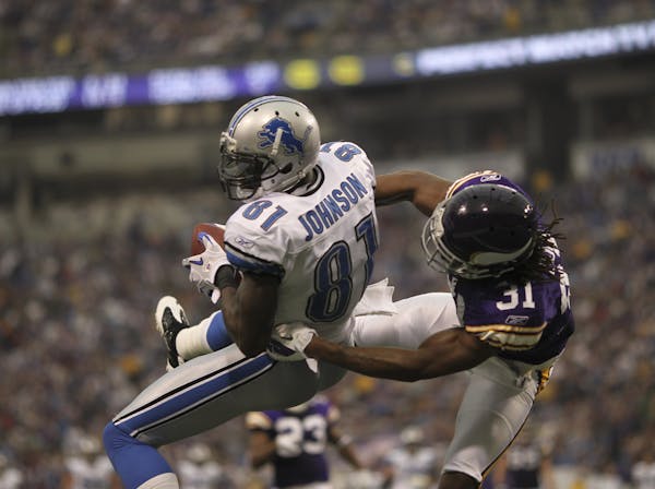 Viking Chris Cook, shown here as Lions Calvin Johnson caught a touchdown pass this season, was arrested Saturday on suspicion of domestic assault.