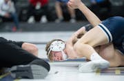 Jackson County Central's Nolan Ambrose watches an official as he tries to pin Belgrade-Brooten-Elrosa's Tanner Viessman in the second round.