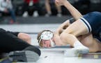 Jackson County Central's Nolan Ambrose watches an official as he tries to pin Belgrade-Brooten-Elrosa's Tanner Viessman in the second round.