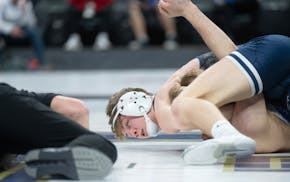 Jackson County Central's Nolan Ambrose watches an official as he tries to pin Belgrade-Brooten-Elrosa's Tanner Viessman in the second round.