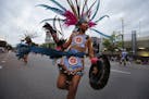 An Aztec dancer with Ketzal Coatlicue participates in the parade.