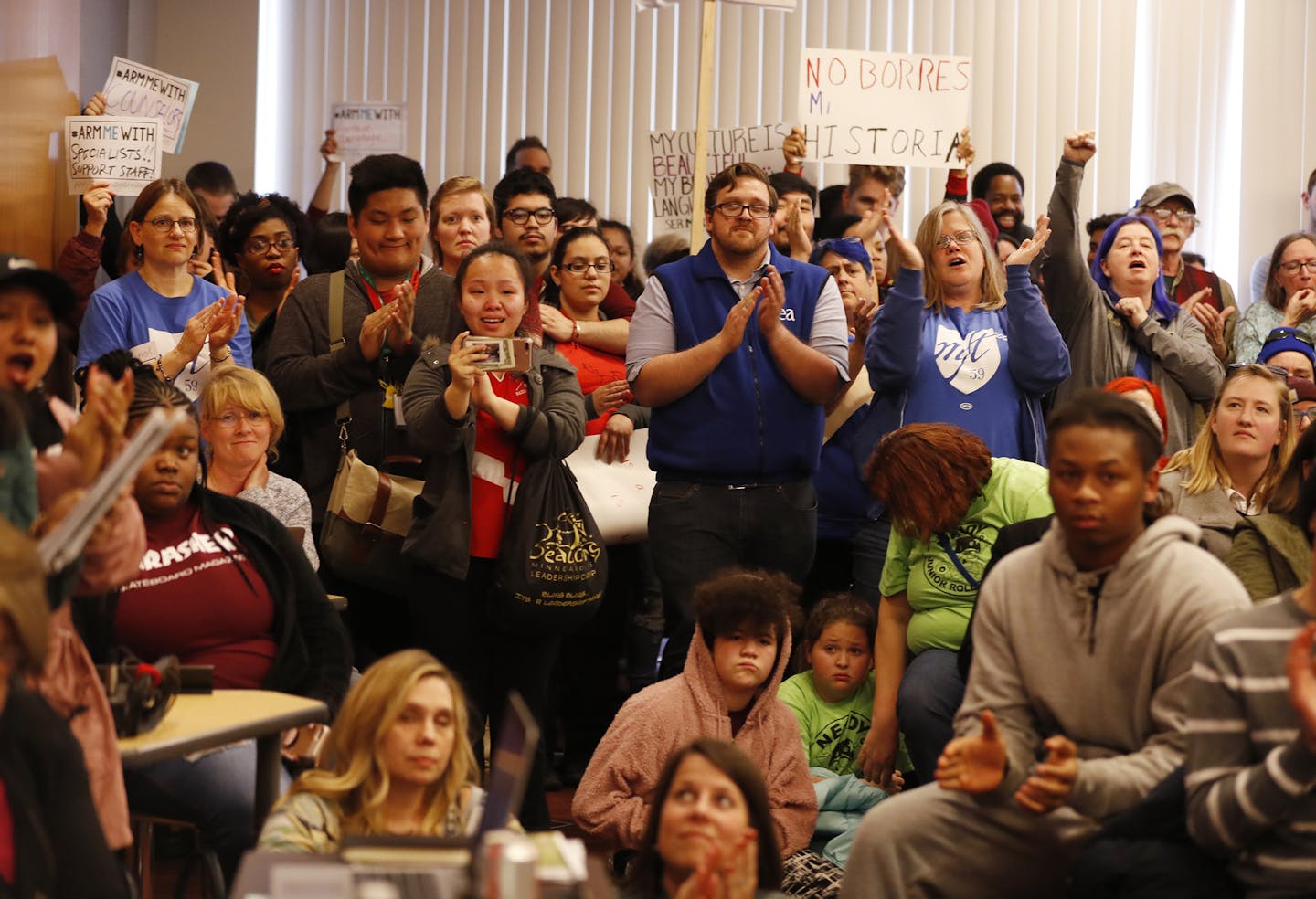 The crowd cheers a speaker during the public comment period. ] LEILA NAVIDI &#xef; leila.navidi@startribune.com BACKGROUND INFORMATION: Parents, students, staff and teachers upset about proposed budget cuts to their individual schools speak during a public comment period at a Minneapolis School Board meeting at the Davis Center in Minneapolis on Tuesday, April 10, 2018.