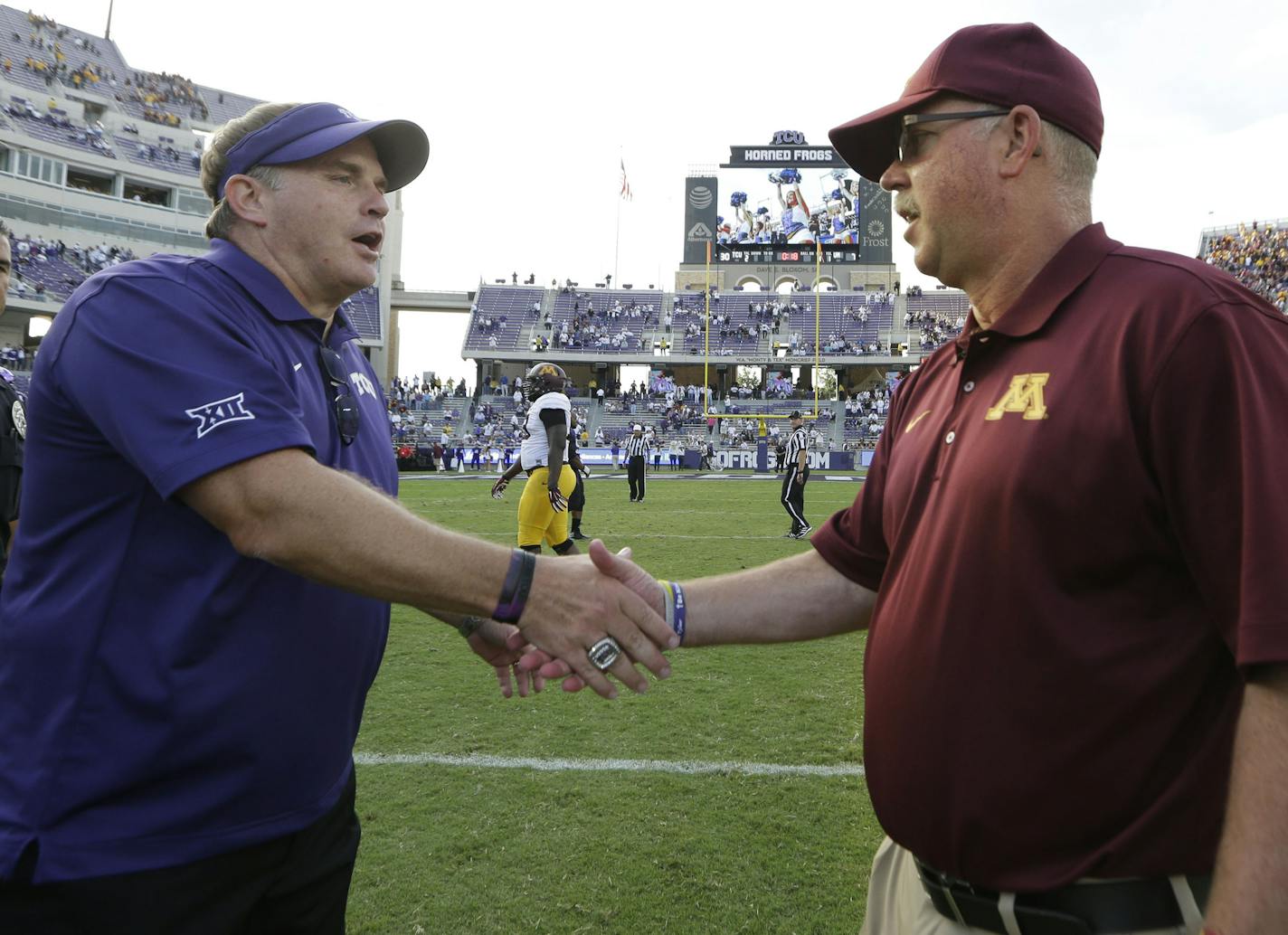 TCU head coach Gary Patterson, left, shakes hands with Minnesota head coach Jerry Kill after their teams played last season.