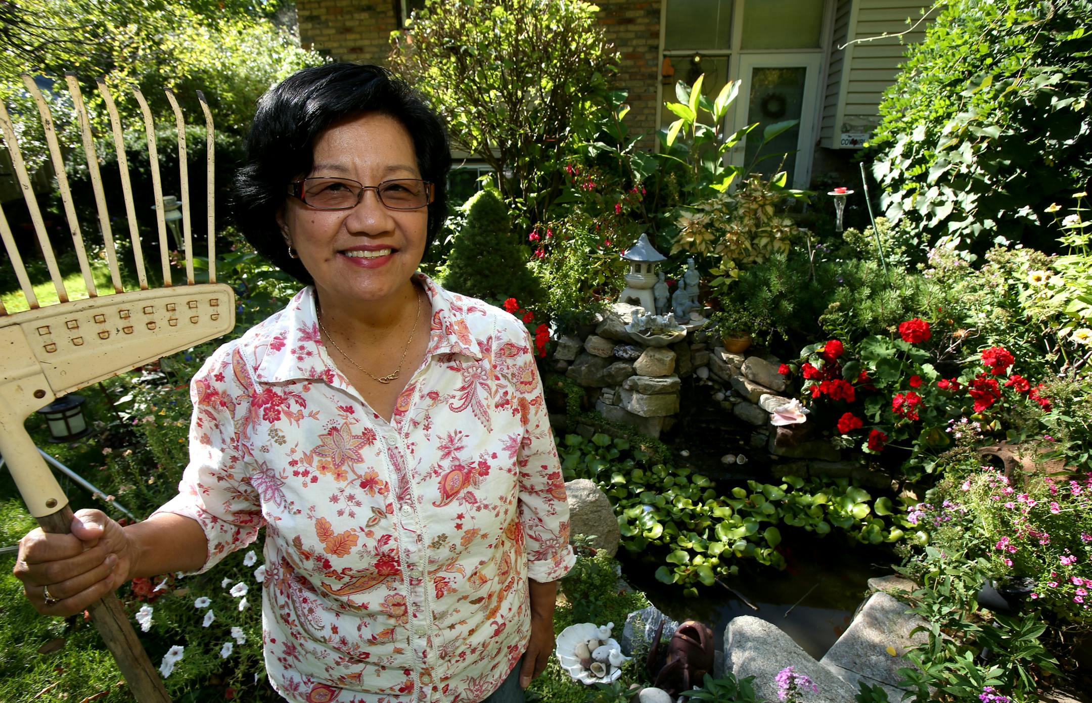 Catherine Navalta Japanese-inspired garden won top honors in New Hope's suburban home awards. Catherine is a born caregiver. She is a registered nurse helping patients recovering from brain injuries and strokes. At home she nurses her spectacular flower garden. She grew up in the Phillipines and remembers the scent of gardenias wafting from her mother's flower garden. New Hope, MN on October 9, 2013. ] JOELKOYAMA‚Ä¢joel koyama@startribune