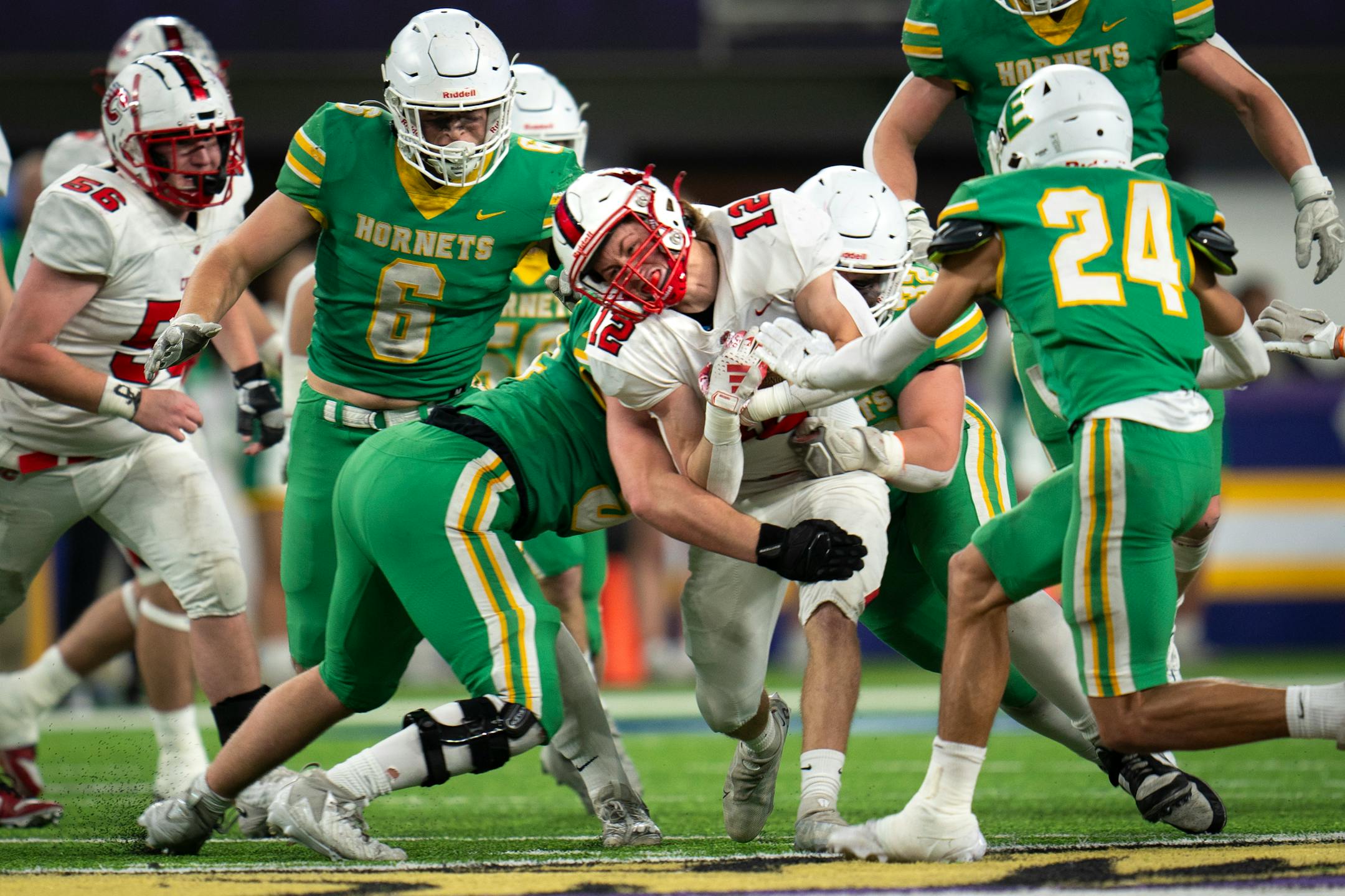 Centennial High School running back/wide receiver Evan Tuttle (12) fights to keep the ball from Edina High School players at the 6a game at U.S. Bank Stadium for the Prep Bowl XLI in Minneapolis on Friday, Nov. 24, 2023. ] Angelina Katsanis • angelina.katsanis@startribune.com