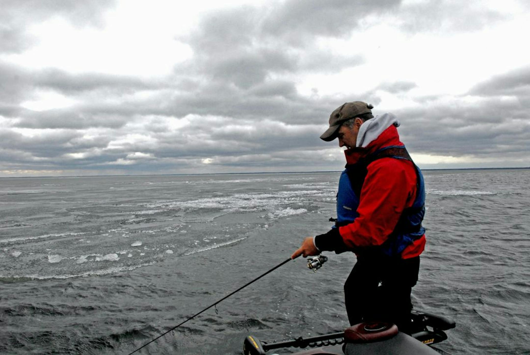 John Heroff of Stillwater tries his luck for walleyes, following the edge of a massive sheet of ice that still covered most of Lake Winnibigoshish on opening day Saturday. Fishing was slow, and anglers were buffetted all day Saturday by frigid winds gusting to 30 miles an hour.