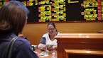 Crystal Kalahiki pays out a bet in the sports book at the South Point hotel-casino, Monday, May 14, 2018, in Las Vegas. The Supreme Court on Monday ga