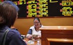 Crystal Kalahiki pays out a bet in the sports book at the South Point hotel-casino, Monday, May 14, 2018, in Las Vegas. The Supreme Court on Monday ga