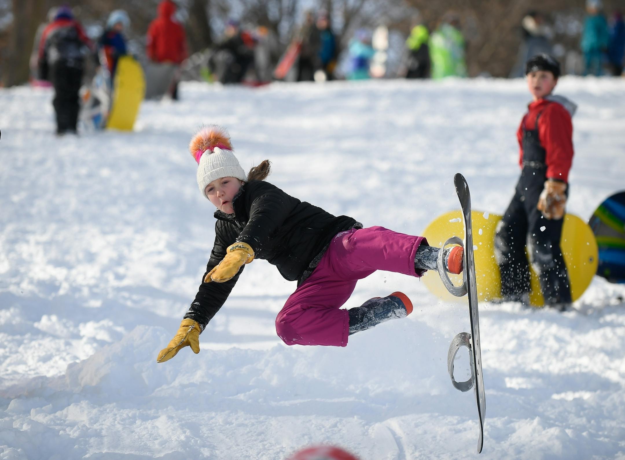 Gillian McMahon, 9, a student a Lake Harriet Community School, bailed off her snowboard as she went off a jump at Beard's Plaisance Tuesday.