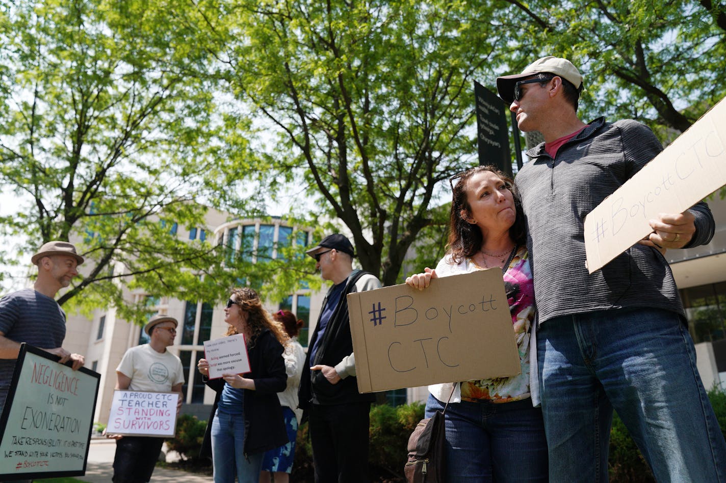 Jina Penn-Tracy, who said Jason McLean and Children's Theatre co-founder John Clark Donahue abused her from 1983 to 1985, became emotional as she stood with her husband, Scott Tracy, during a protest outside the theater.