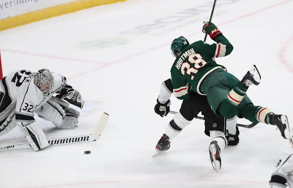 Ryan Hartman (38) of the Minnesota Wild Is unable to get the puck past Los Angeles Kings goalie Jonathan Quick (32) during the first period.