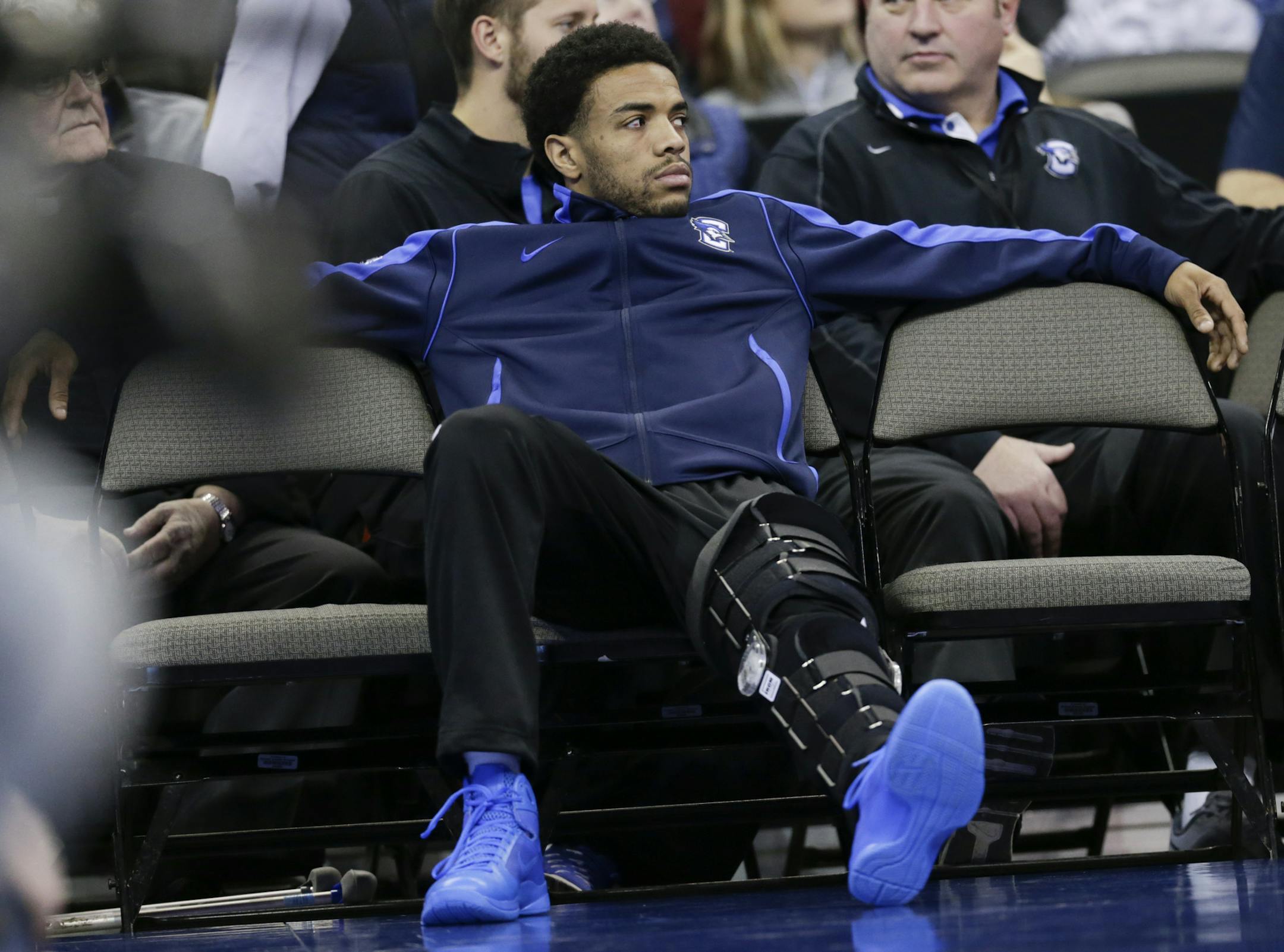 Creighton's Maurice Watson Jr., out for the season due to a torn ACL, sits on the bench during the second half of an NCAA college basketball game against Marquette in Omaha, Neb., Saturday, Jan. 21, 2017. Marquette won 102-94. (AP Photo/Nati Harnik) ORG XMIT: NENH111