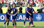 Japan's Rumi Utsugi (13), Mizuho Sakaguchi (6), Yuki Ogimi (17) and Nahomi Kawasumi (9) celebrate a 2-1 win over England in a semifinal in the FIFA Wo