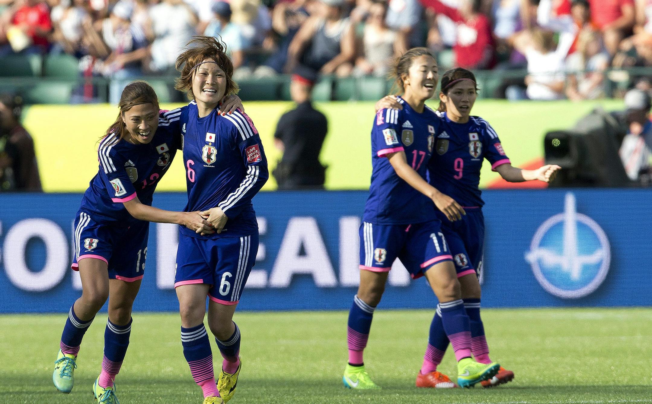 Japan's Rumi Utsugi (13), Mizuho Sakaguchi (6), Yuki Ogimi (17) and Nahomi Kawasumi (9) celebrate a 2-1 win over England in a semifinal in the FIFA Women's World Cup soccer tournament, Wednesday, July 1, 2015, in Edmonton, Alberta, Canada. Japan won 2-1. (Jason Franson/The Canadian Press via AP)