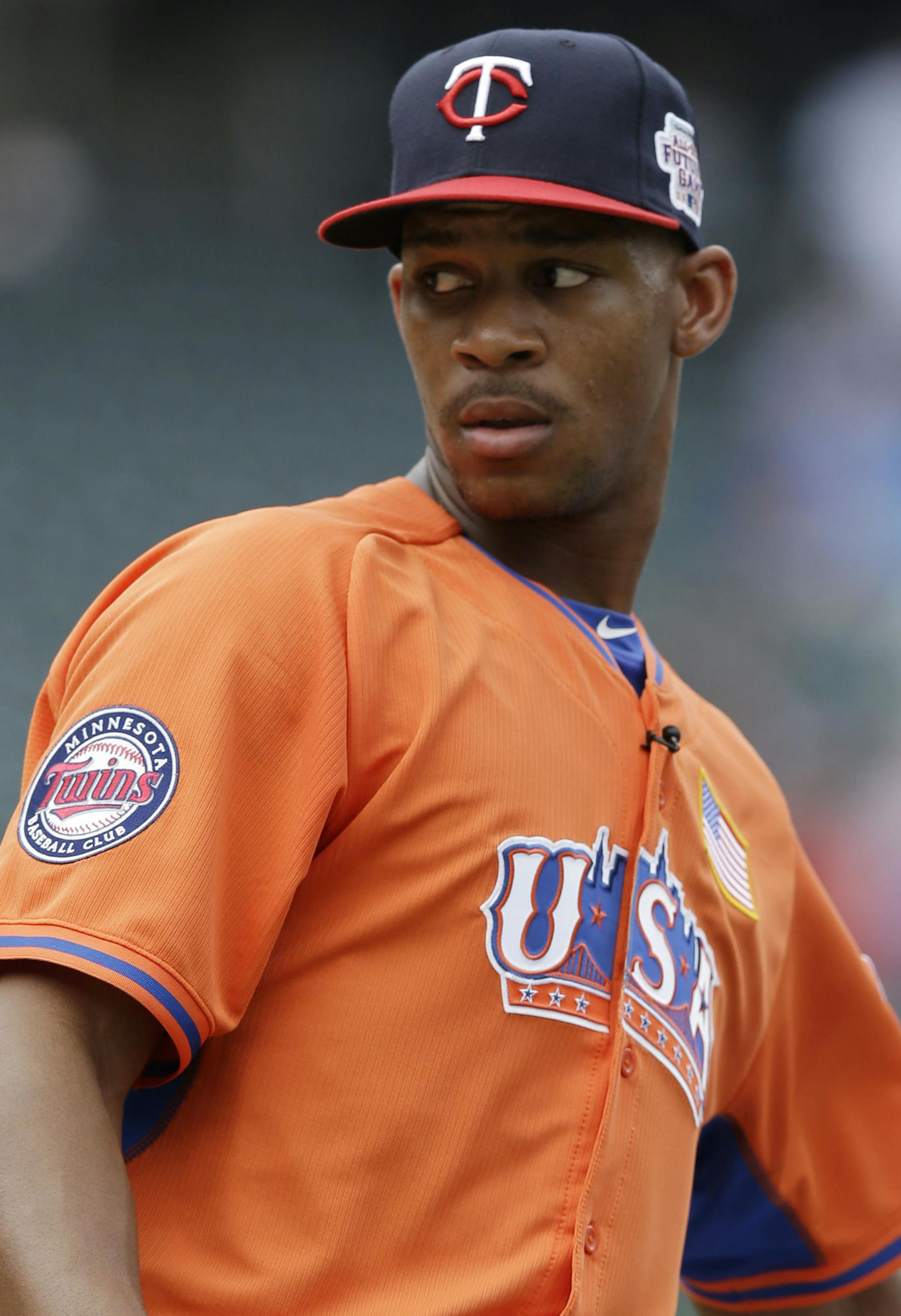 United States' Byron Buxton drops balls near the batting cage before the MLB All-Star Futures baseball game against the World Team, Sunday, July 14, 2013, in New York. (AP Photo/Kathy Willens)
