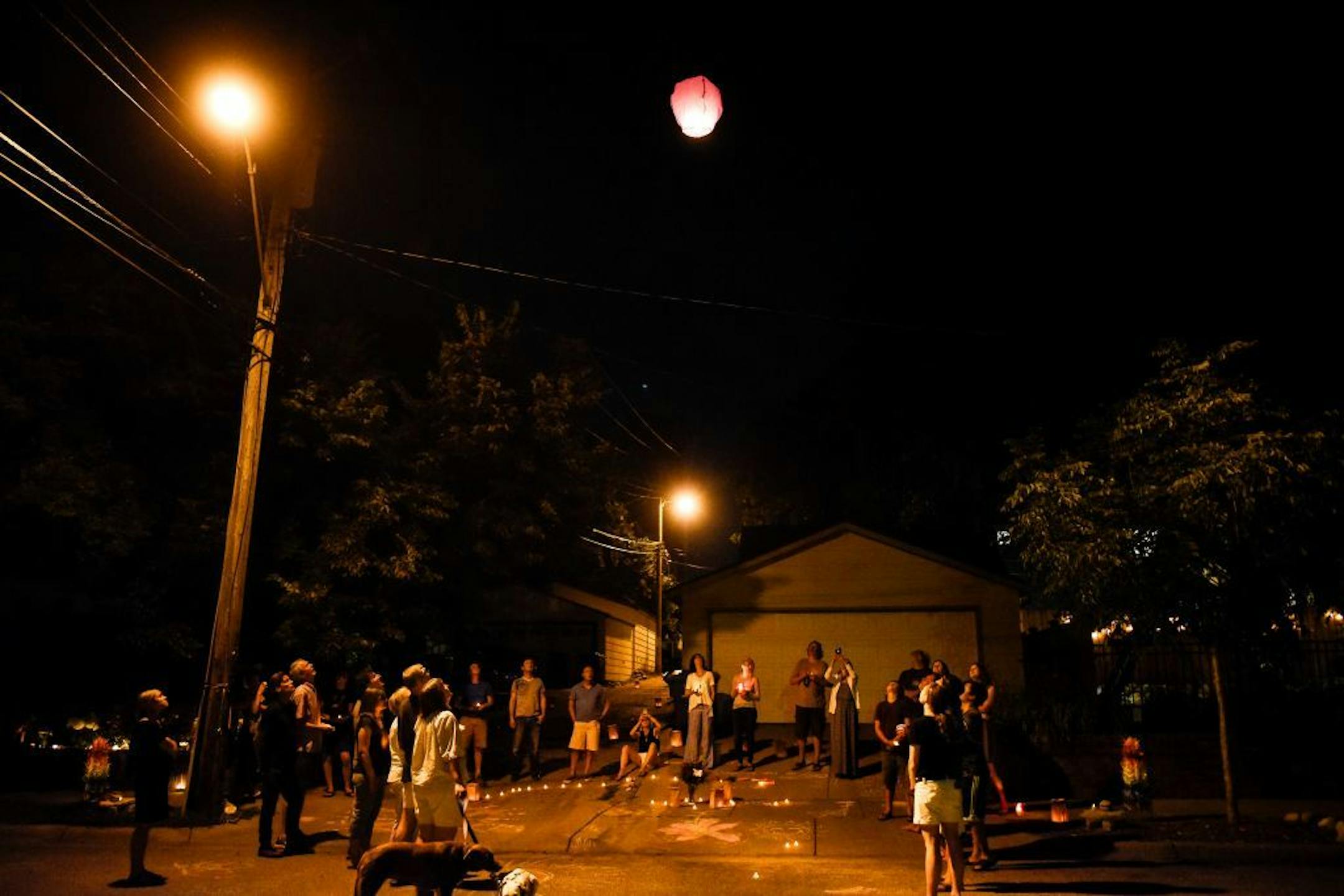 Jenelle and Ryan Masterson, neighbors of Don Damond, released a lantern into the sky during a memorial for Justine Damond Ruszczyk Saturday night.