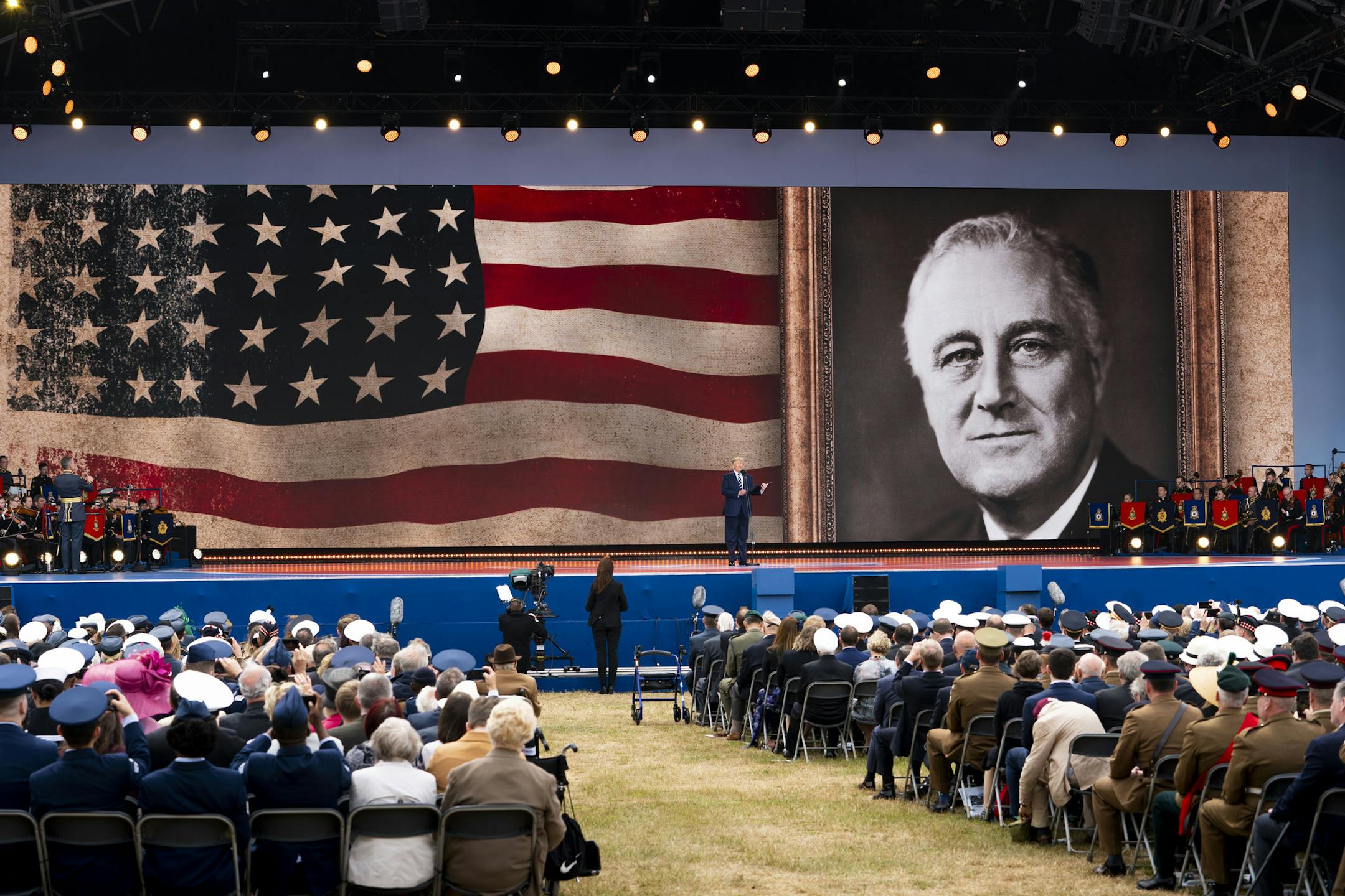 President Donald Trump takes the stage under a portrait of President Franklin D. Roosevelt during a D-Day commemoration at the British naval base in Portsmouth, England, on Wednesday, June 5, 2019. Trump read an excerpt from a prayer delivered by Roosevelt on the radio on the eve of the D-Day operation. (Doug Mills/The New York Times)