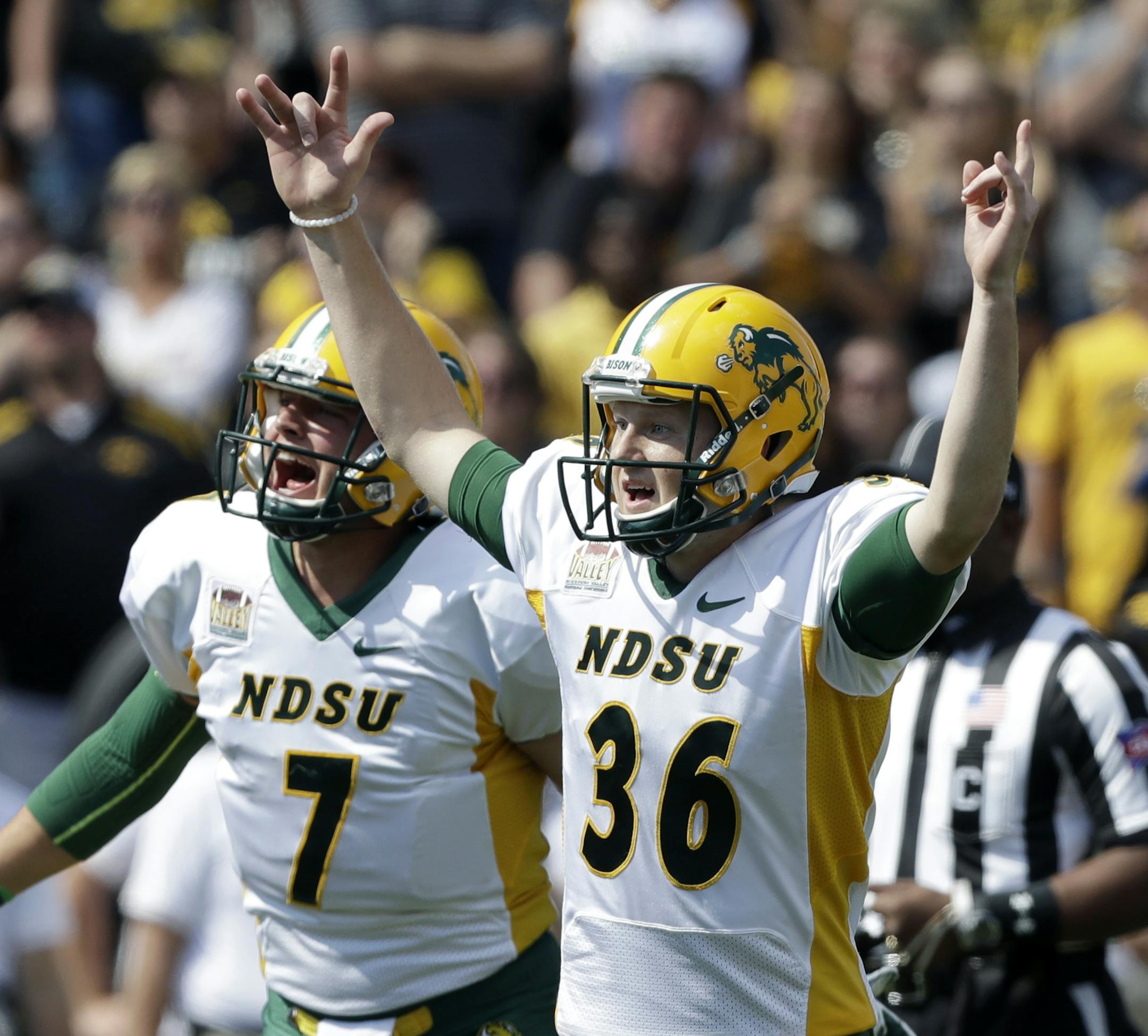 North Dakota State kicker Cam Pedersen (36) reacts with holder Cole Davis (7) after kicking a 37-yard field goal on the final play of an NCAA college football game against Iowa, Saturday, Sept. 17, 2016, in Iowa City, Iowa. North Dakota State won 23-21. (AP Photo/Charlie Neibergall)