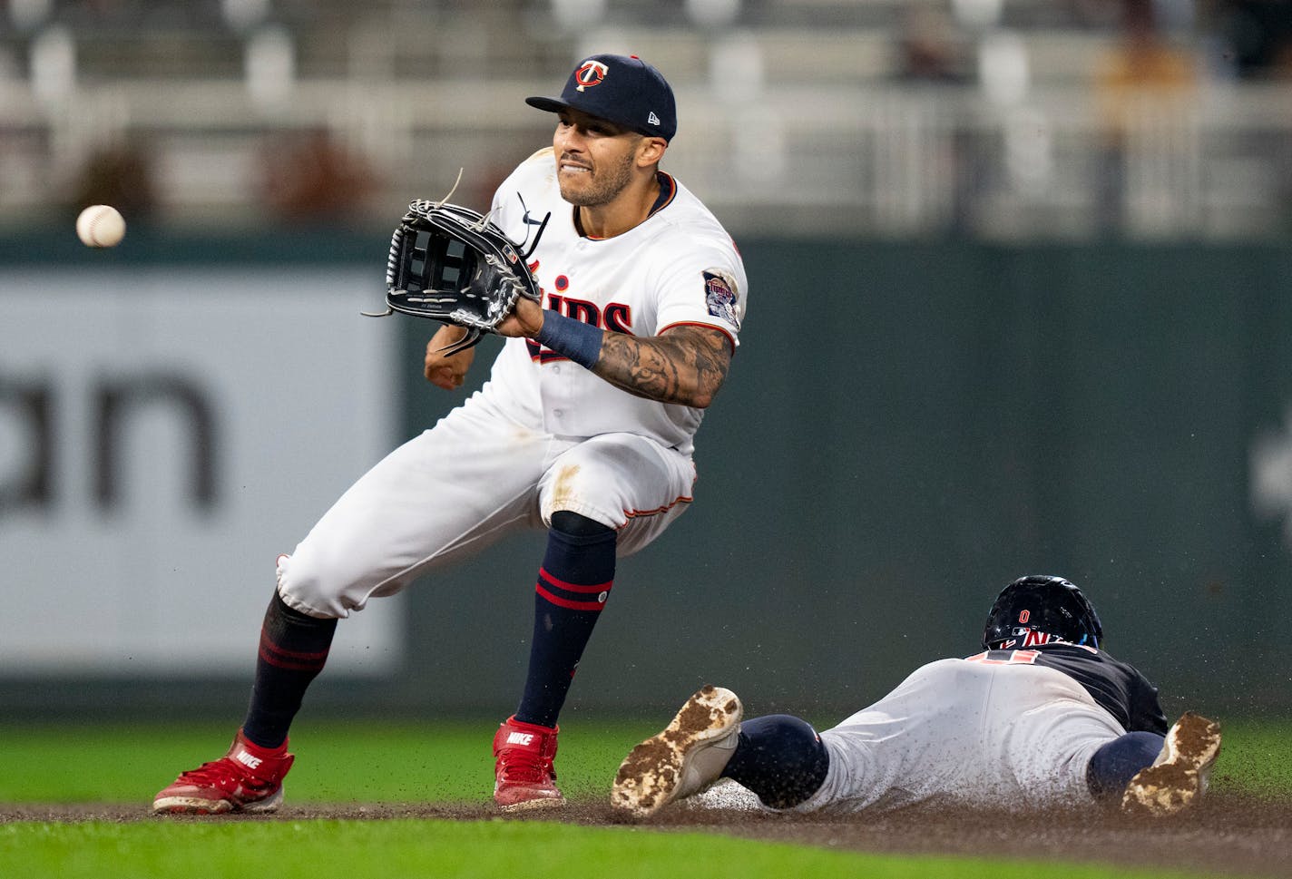 Minnesota Twins shortstop Carlos Correa (4) attempts to pick off Cleveland Guardians second baseman Andrés Giménez (0) who was called safe in the seventh inning Friday, September 9, 2022 at Target Field in Minneapolis. ]