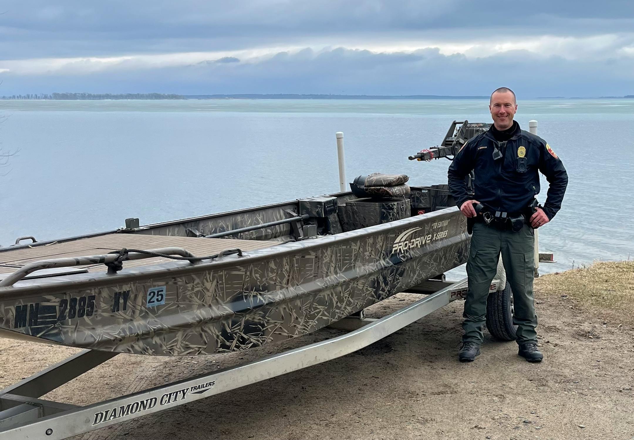 DNR conservation officer Levi Brown of Benson saved the life of a man whose head was pinned between a forklift and a tractor tire. DNR photo.